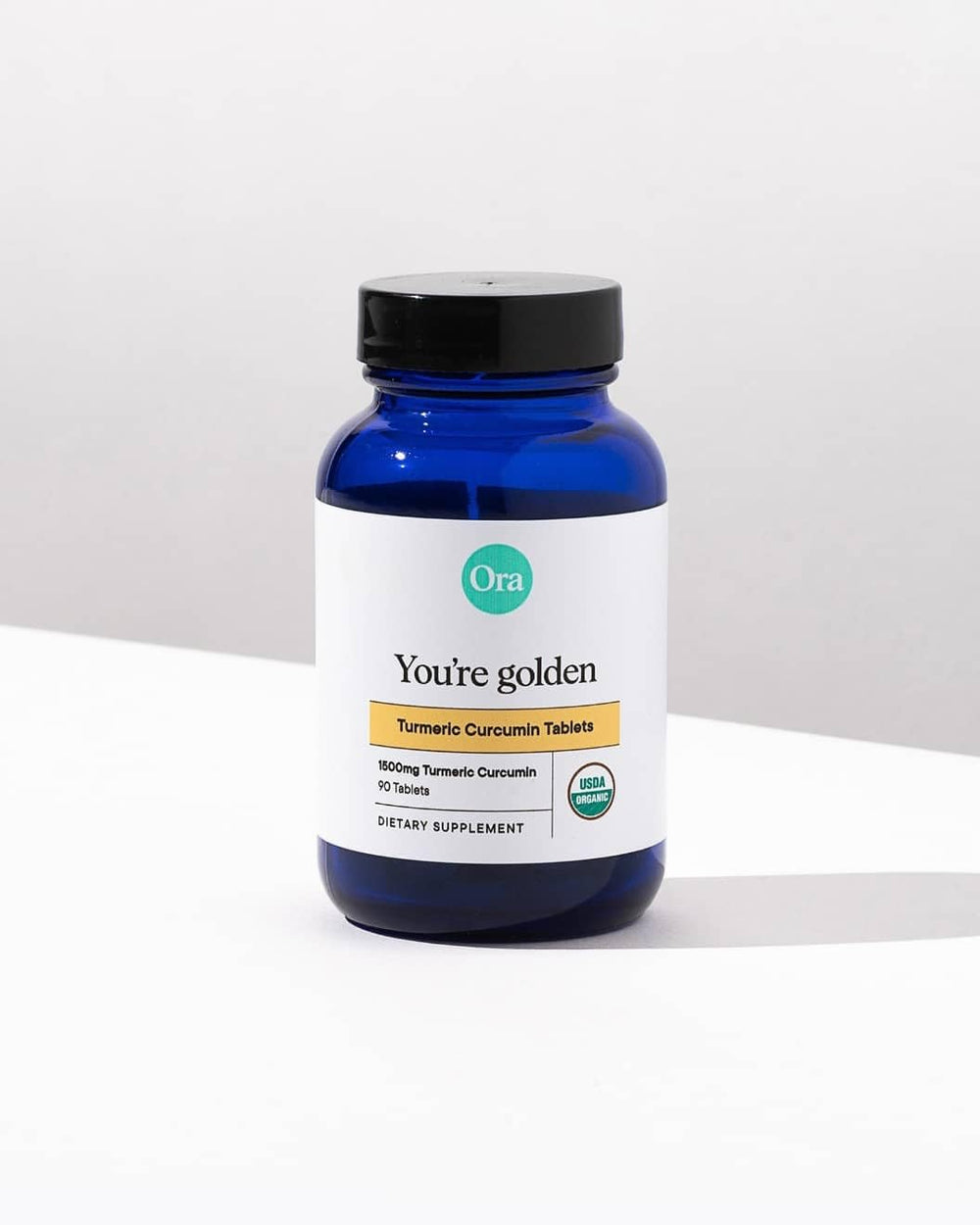 Ora Organic Turmeric Curcumin bottle bathed in natural light for premium feel.