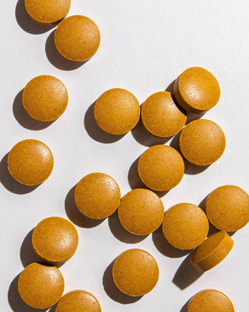Ora Organic Turmeric Curcumin tablets on hand illustrating daily health use.