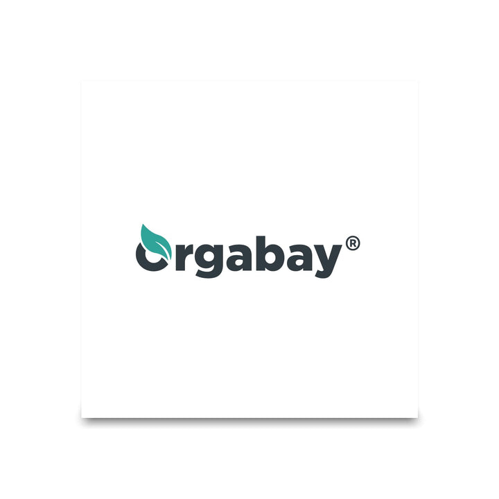 Orgabay bottle beside glass of water implying daily supplementation