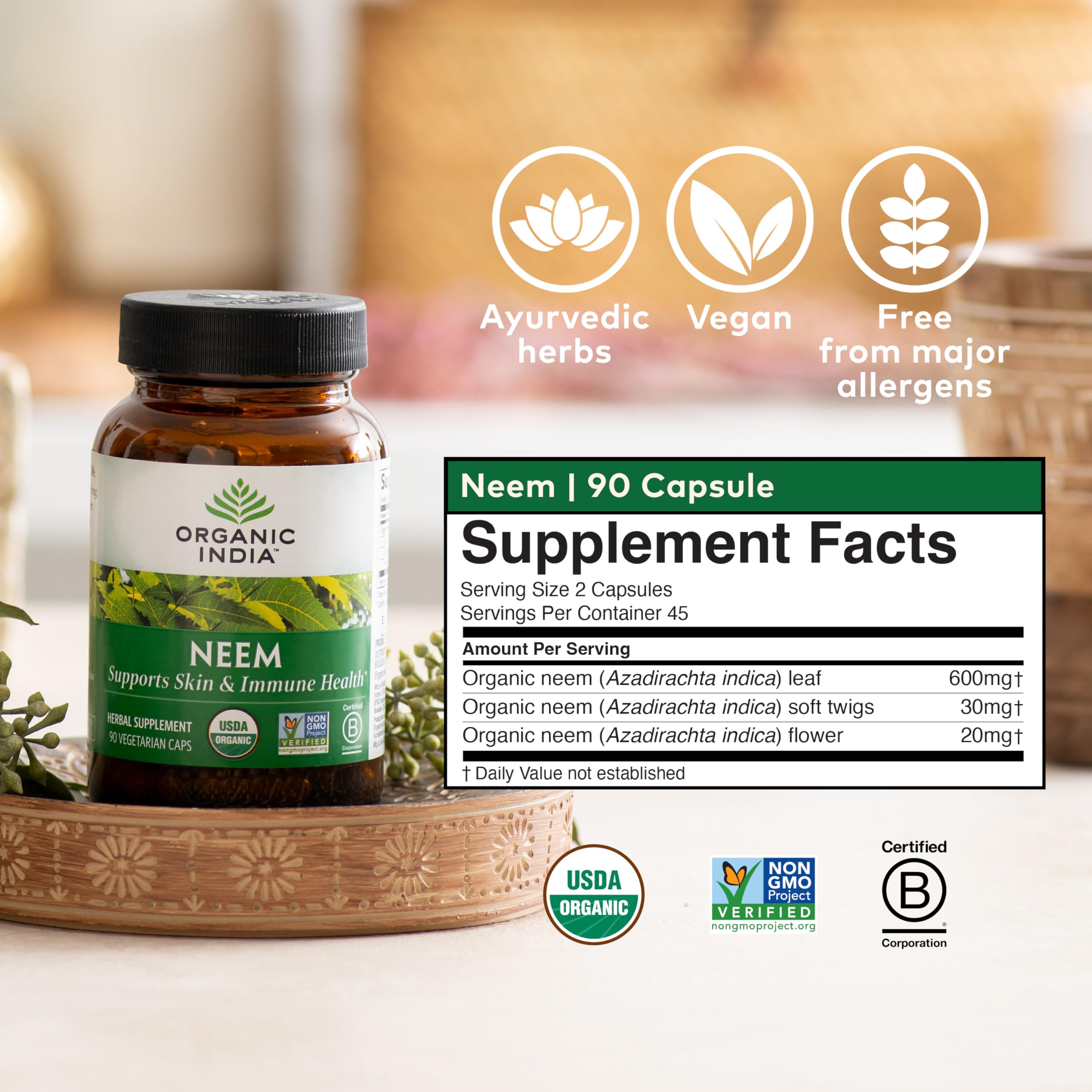 ORGANIC INDIA Neem Leaf Capsules with a glass of water for daily intake.