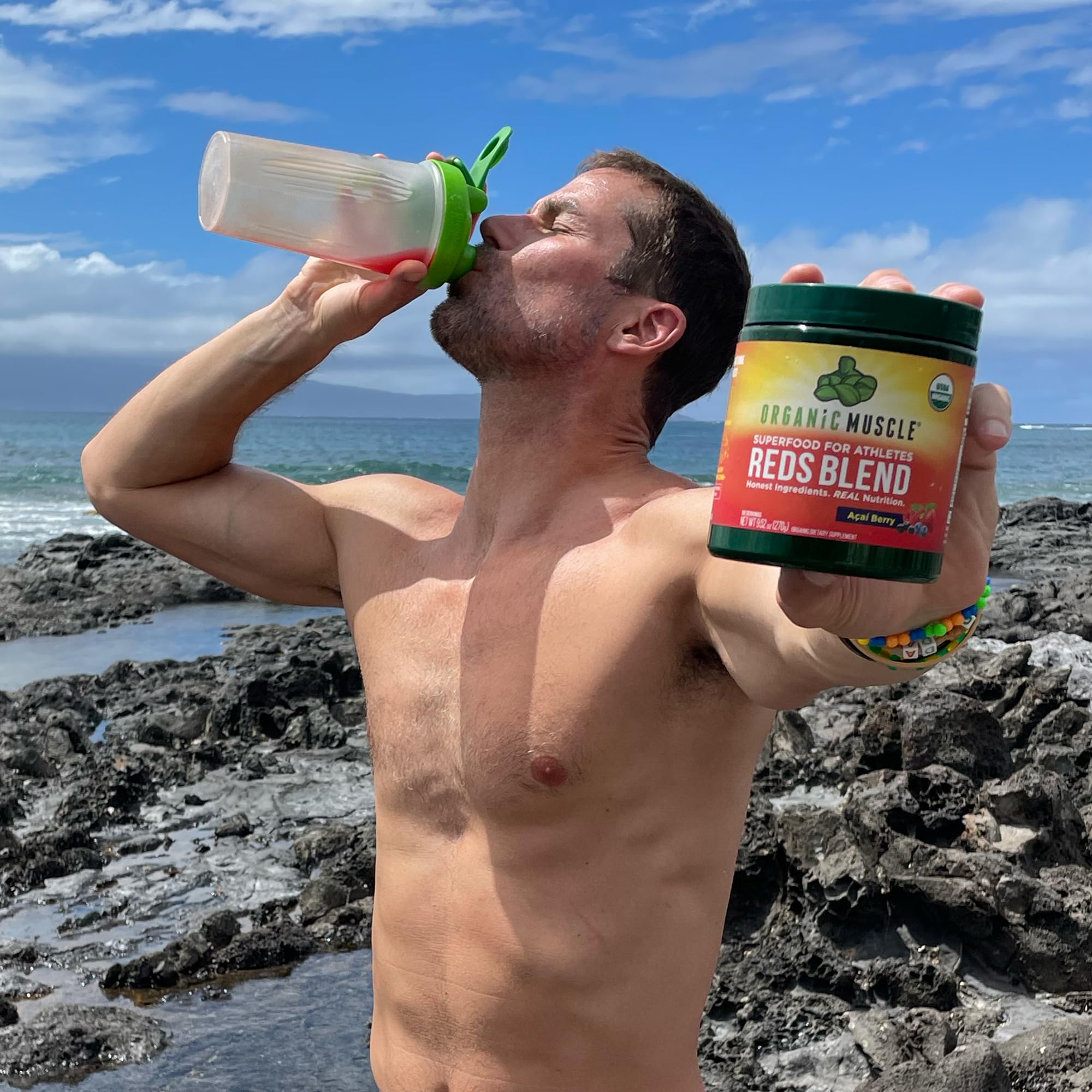 Organic Muscle Reds Powder being poured into water for a clean hydration boost.