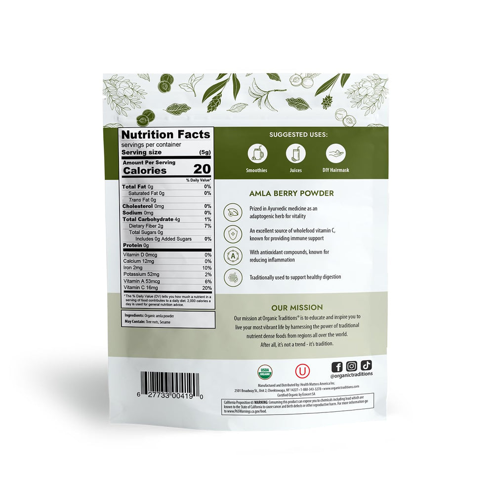 Organic Traditions Amla powder on a kitchen counter with fresh ingredients.