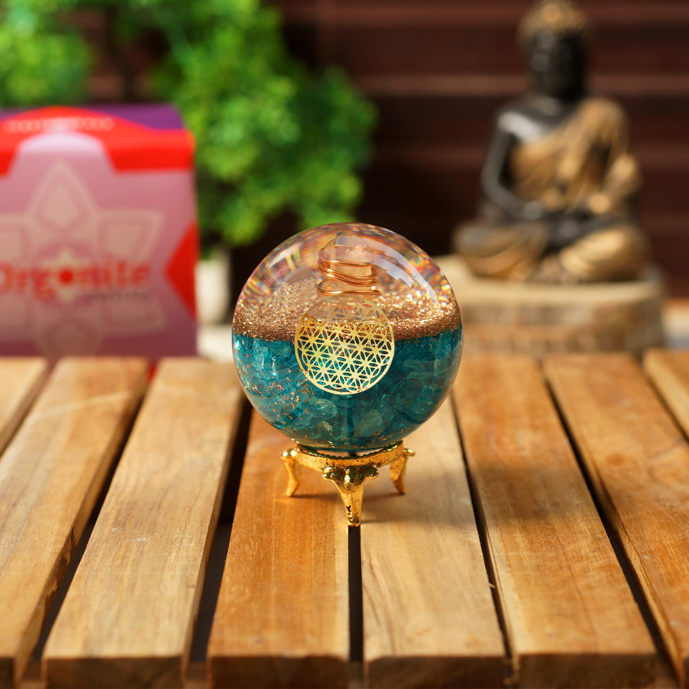 Orgonite Crystal Blue Aquamarine Ball with Flower of Life symbol enhances serene ambiance.