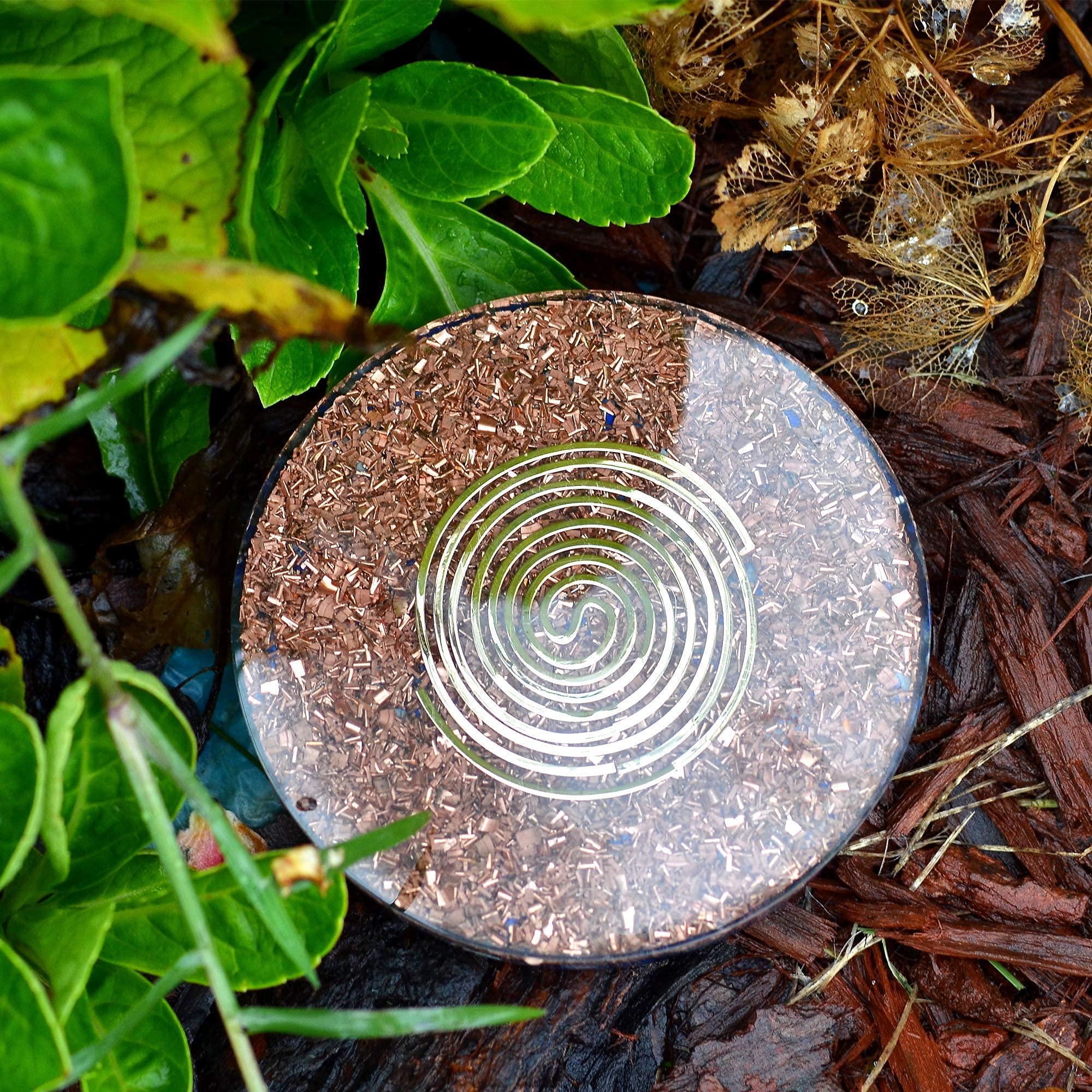 Orgonite Crystal Water Charging Plate with glass of water energizes hydration rituals.