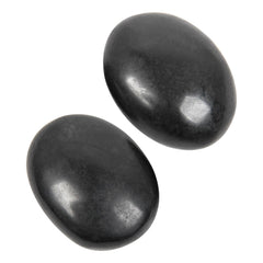 Orientrea black tourmaline palm stone held for grounding and focus.