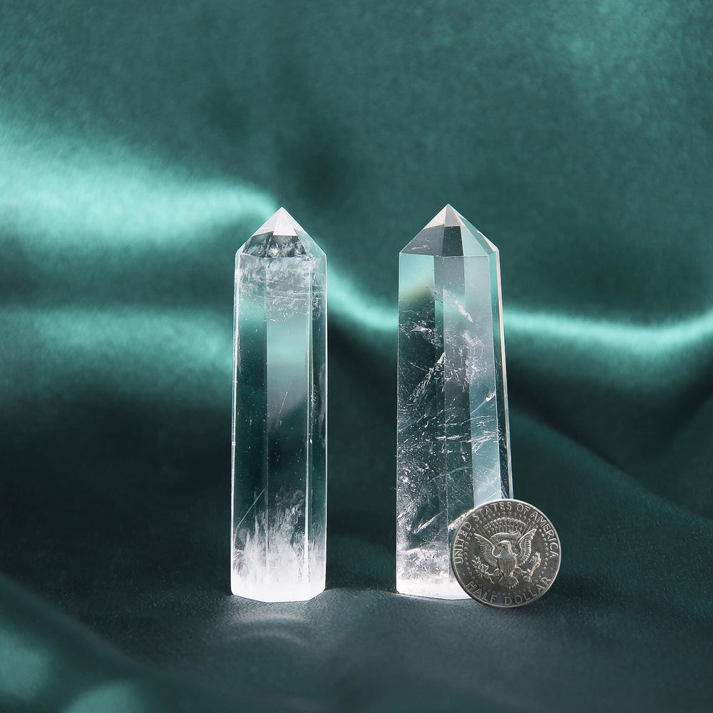 Handcrafted Orientrea clear quartz wand showing natural facets and artisan finish.