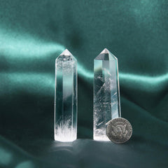 Handcrafted Orientrea clear quartz wand showing natural facets and artisan finish.