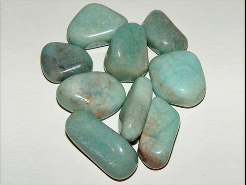 Pachamama Essentials Amazonite tumbled stone in hand for grounding and balance.