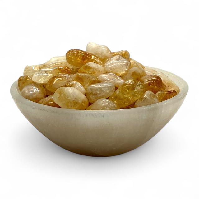 Pachamama Essentials Citrine tumbled stone placed in a cash drawer for focus and abundance