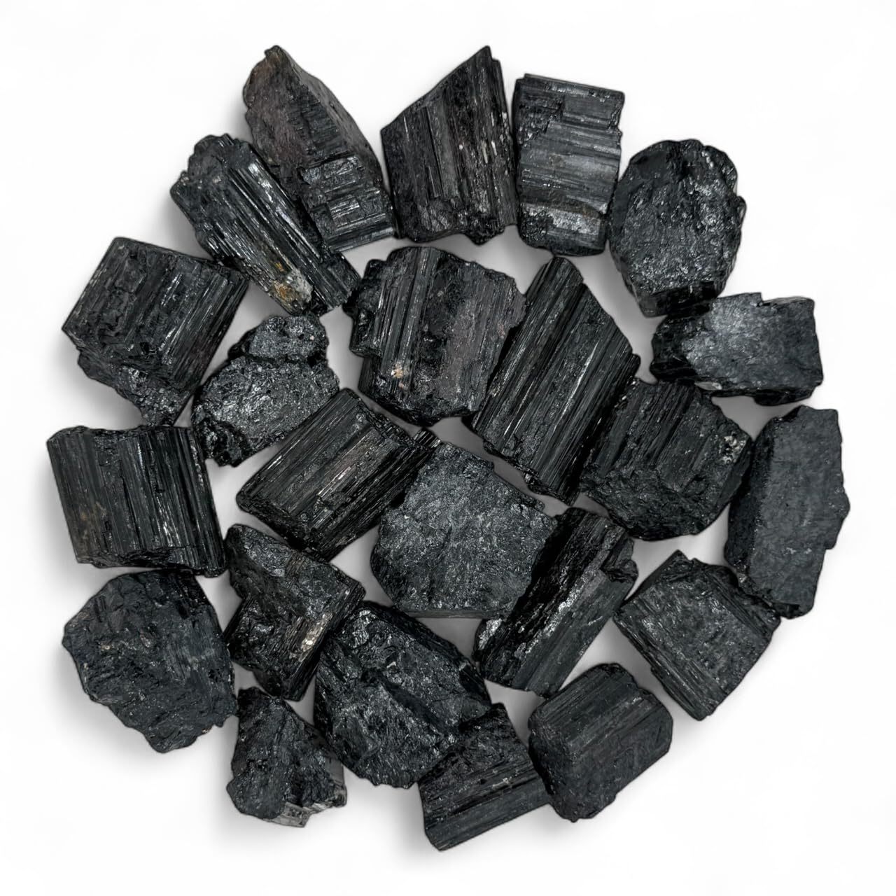 Pachamama Essentials rough black tourmaline stones for grounding and focused work.