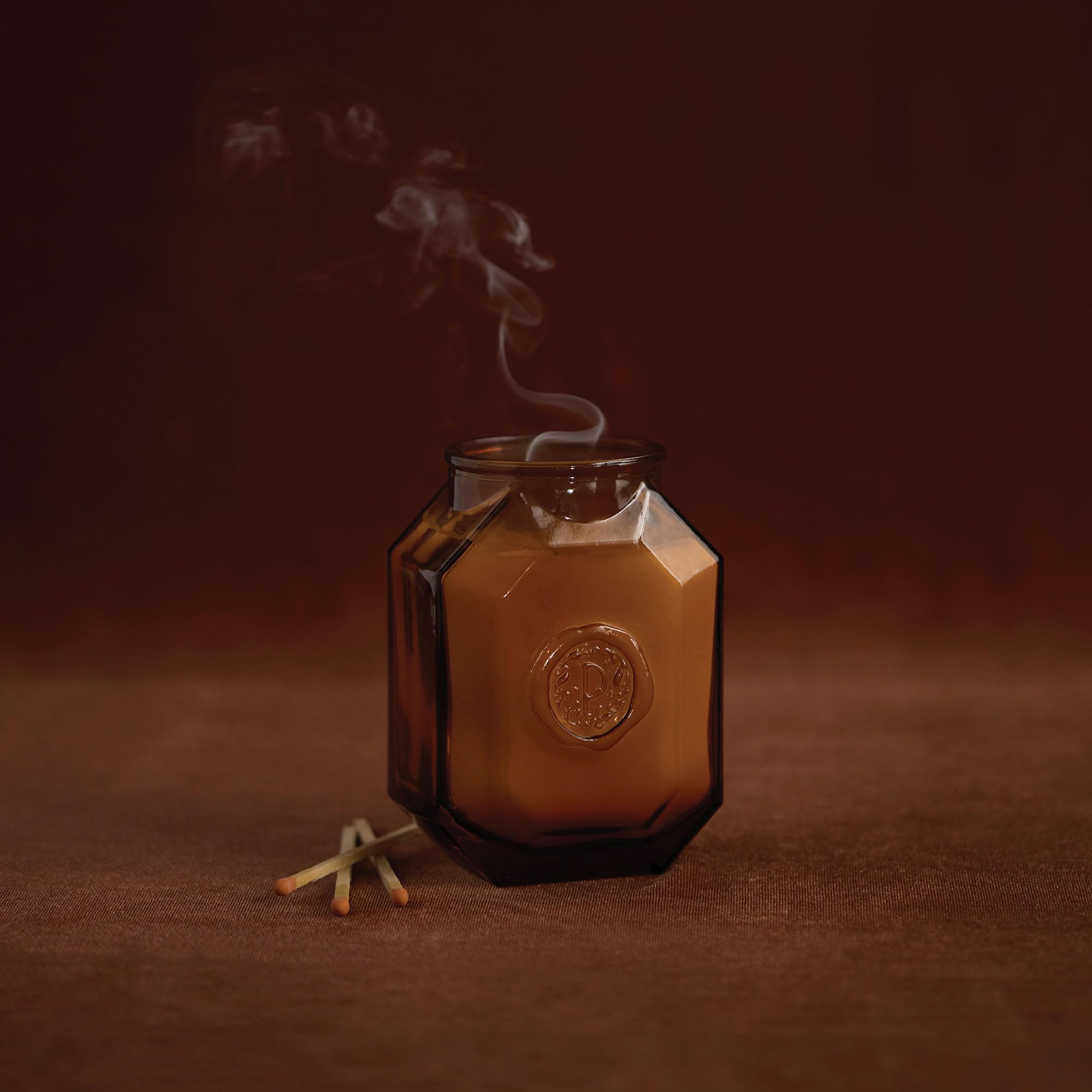 Paddywax Botanica candle with lid and embossed jar showcases elegant design for gifting.
