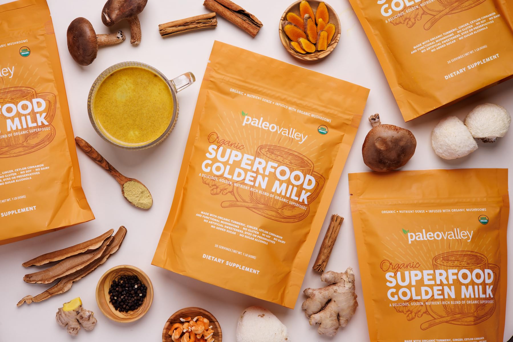 Paleovalley Golden Milk powder scoop captures preparation for a mug.