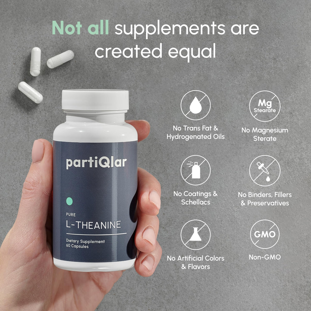 partiQlar Pure L-Theanine capsules on table with glass of water for daily use.