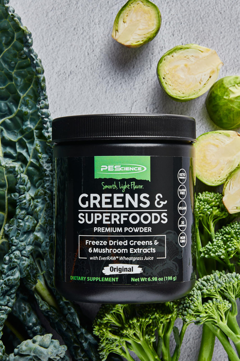 PEScience Greens Powder on kitchen counter suggests easy daily use.