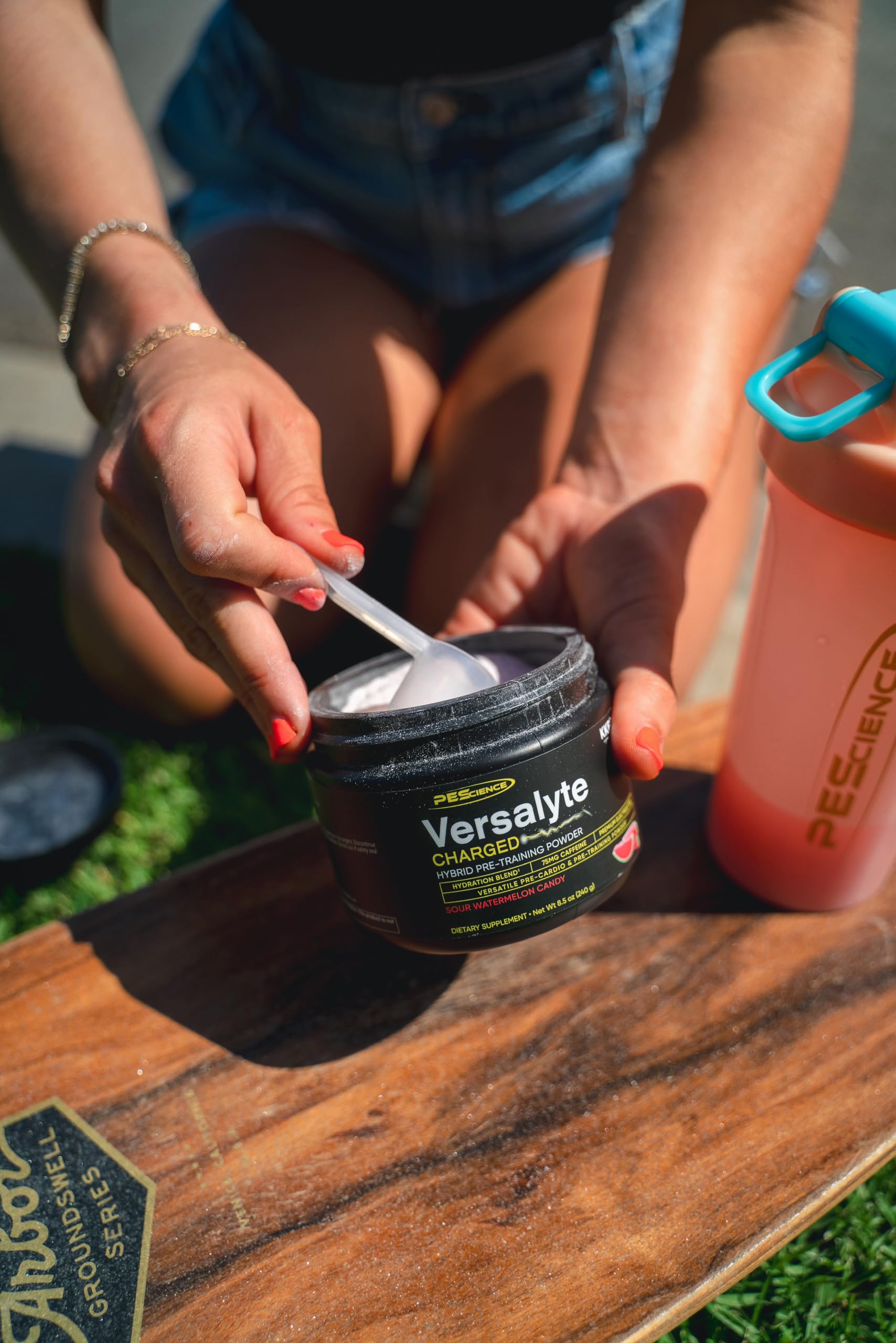 Dissolving Versalyte Charged powder in water with a refreshing tart glow