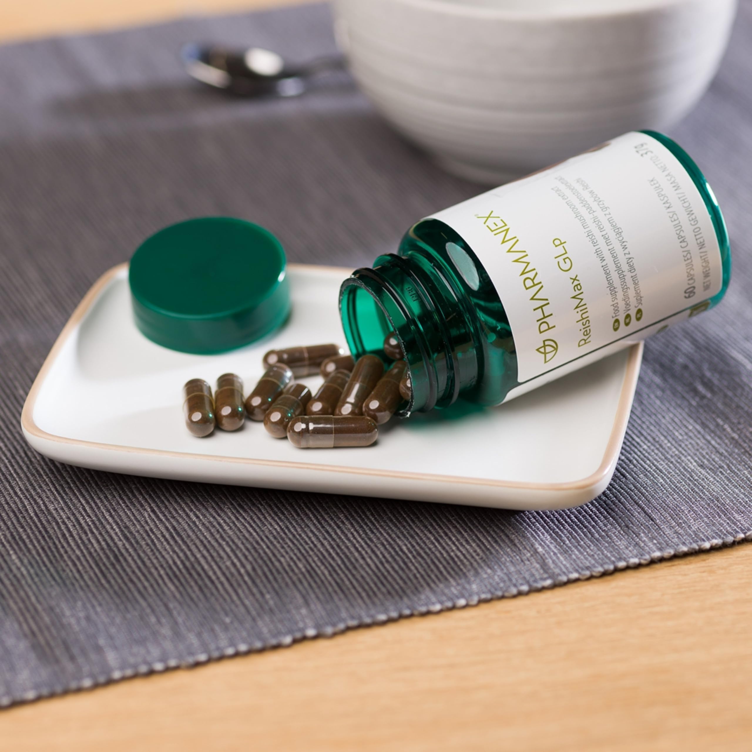 Pharmanex ReishiMax GLp capsules laid out for daily wellness routine
