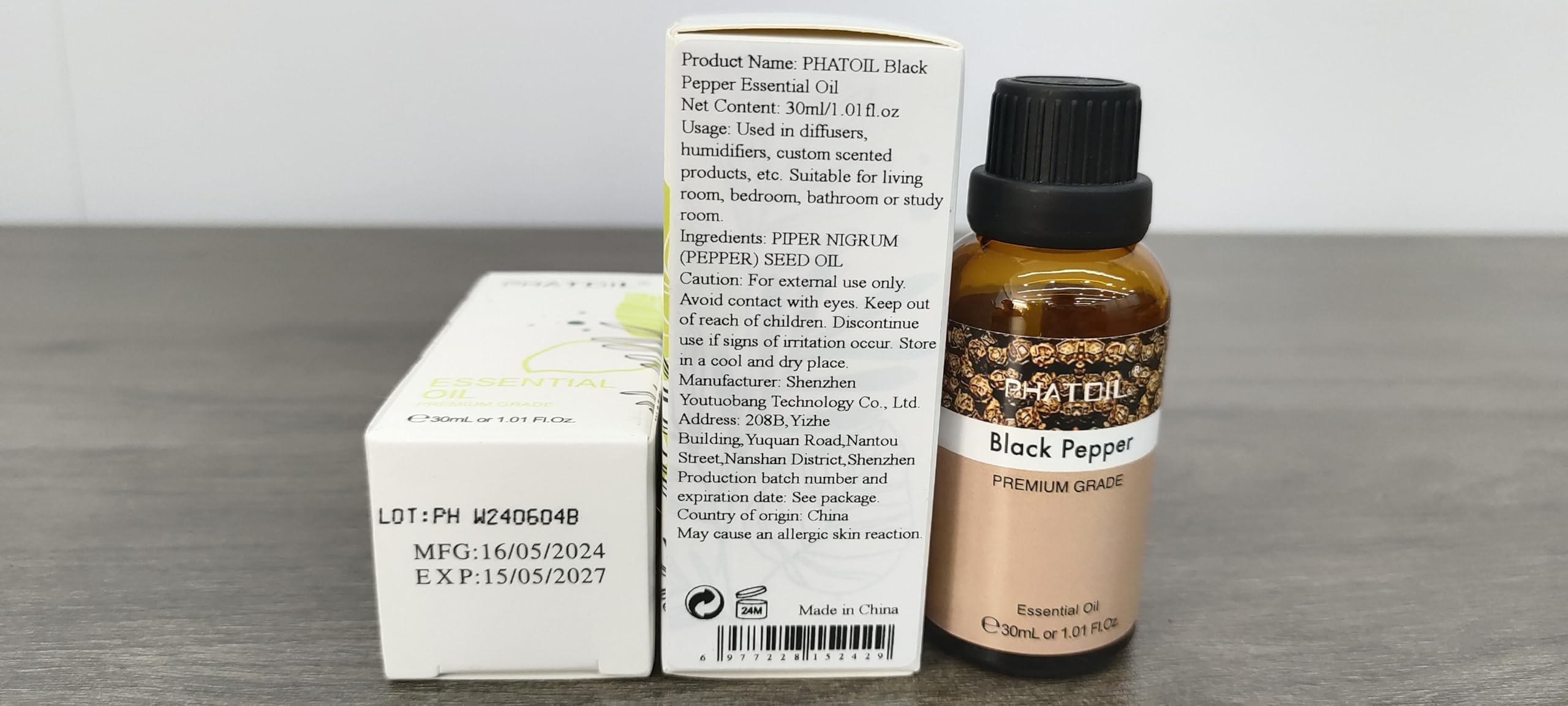 PHATOIL Black Pepper essential oil packaging display on a shelf