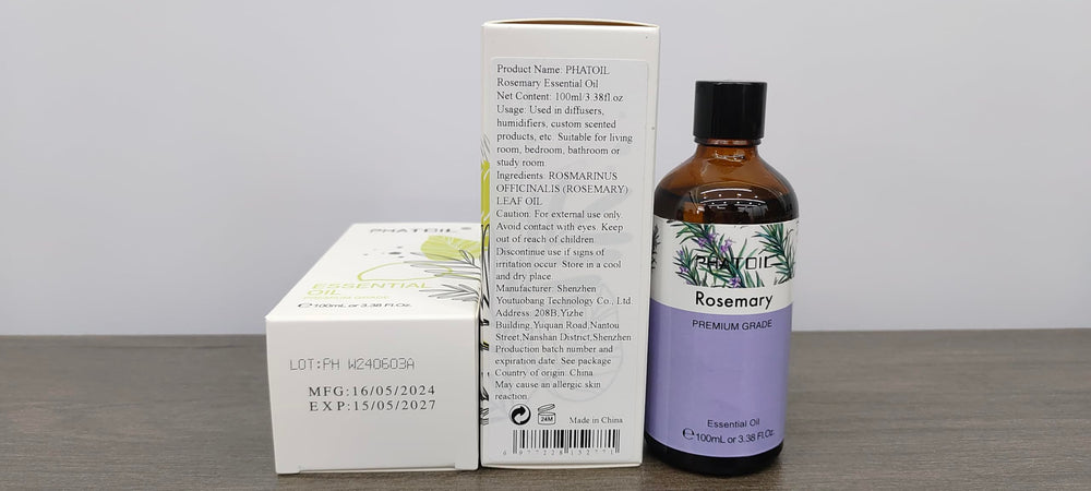 Close-up of PHATOIL rosemary oil bottle with built-in dropper for precise pouring.