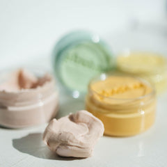 Hand squeeze action demonstrates pliable putty for portable mindful breaks