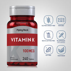 Piping Rock Vitamin K tablets held in hand highlighting easy-to-swallow design.