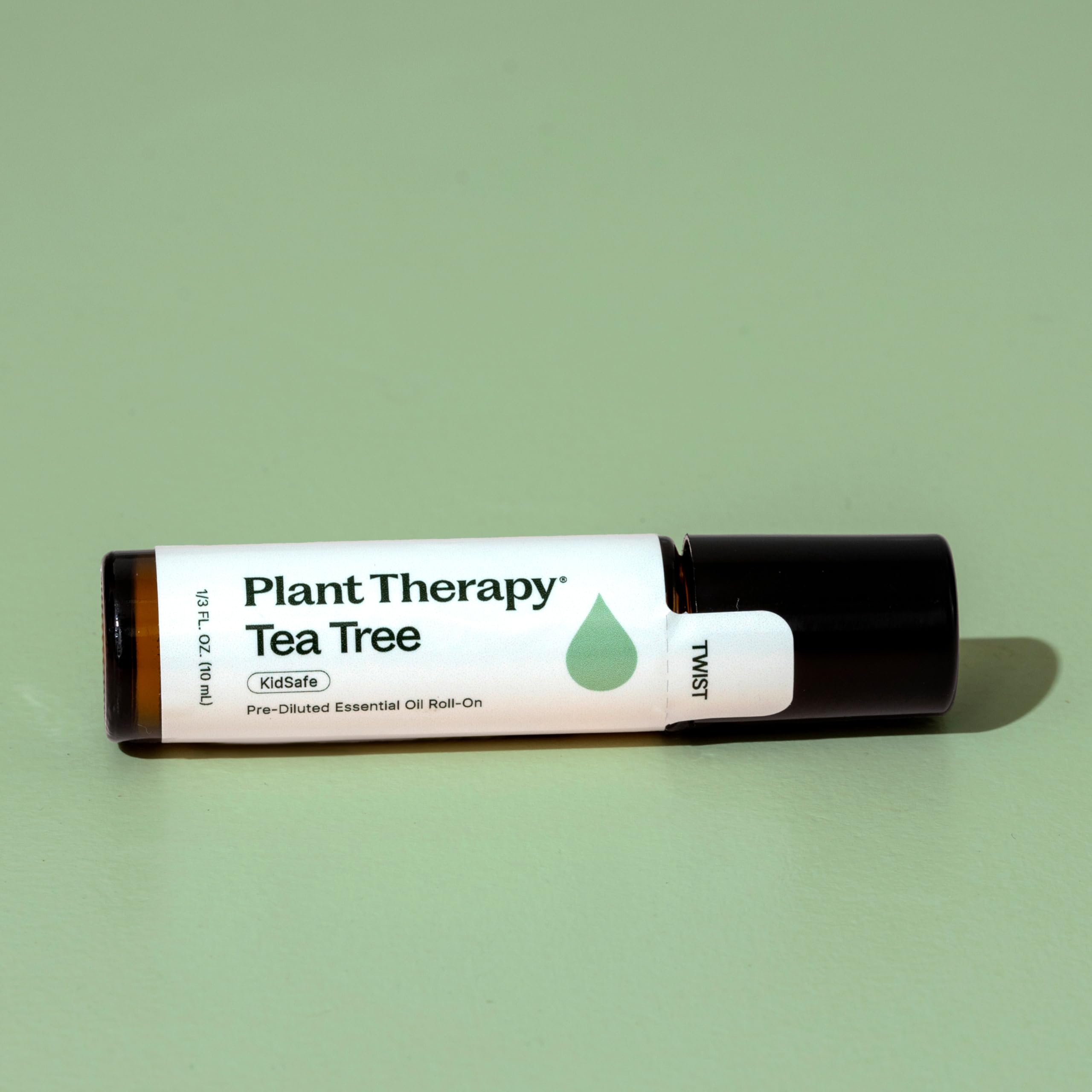 Plant Therapy Tea Tree Roll-On in hand for discreet, portable use.