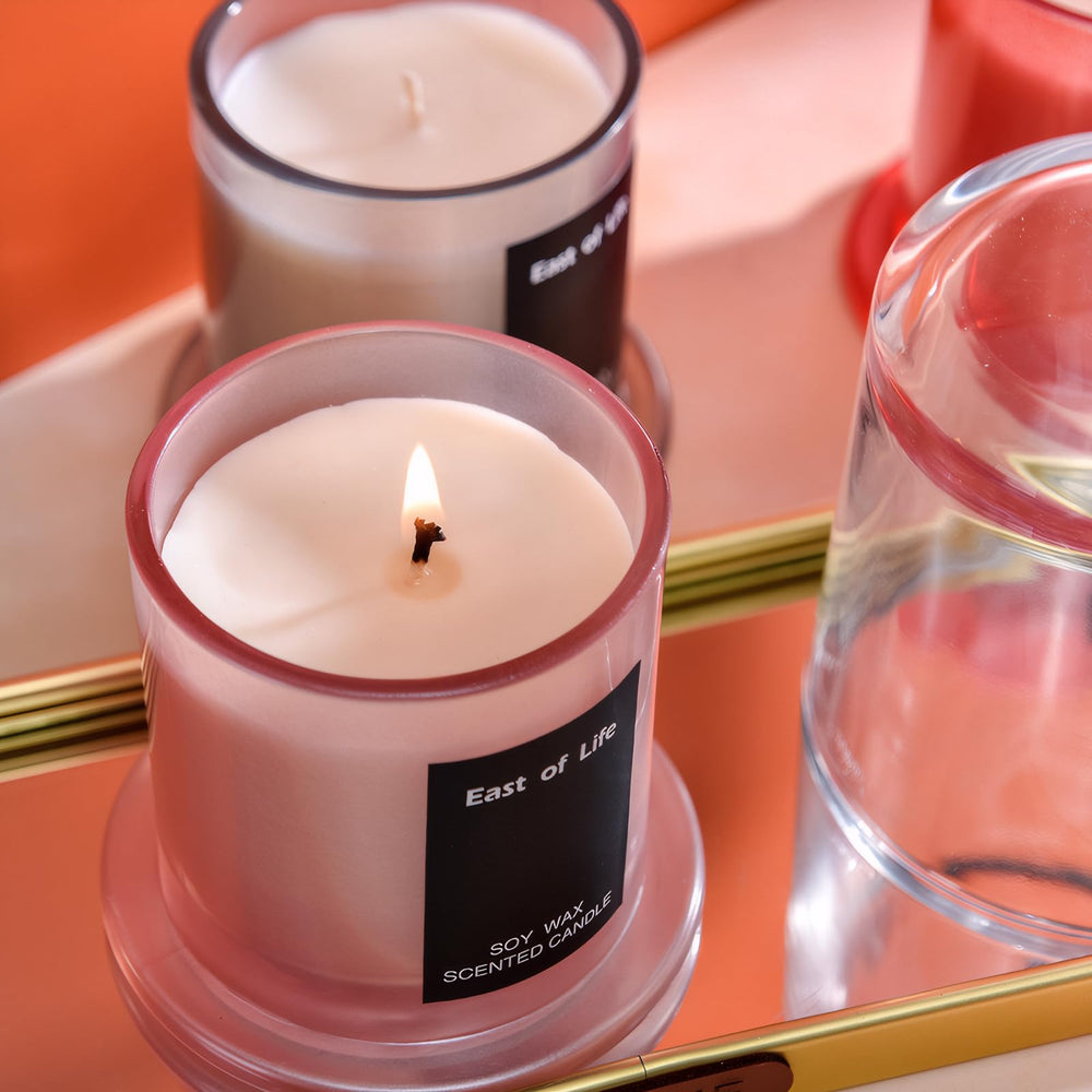 Exquisite glass cup candle with decorative packaging, ideal as a gift.