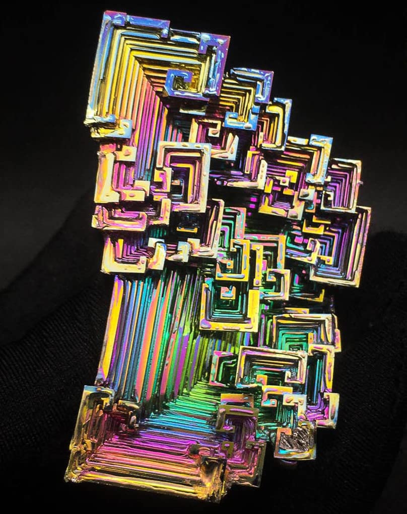 Pounique bismuth crystal triangular structure sparks study and collection.