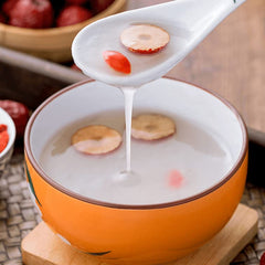 President Brand Kudzu powder on a spoon beside a glass of warm water