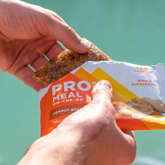 Probar Meal Bar Peanut Butter bite reveals nuts and oats, wholesome pick-me-up.