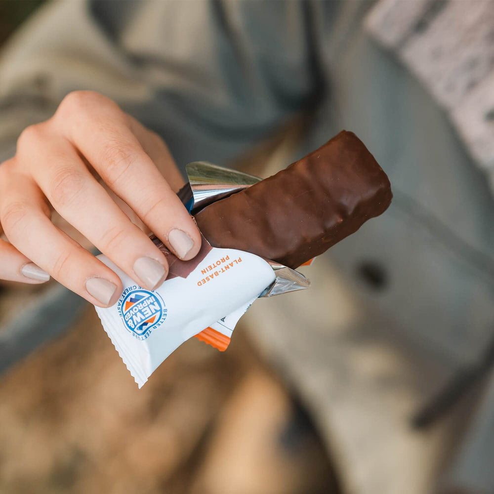ProBAR Sea Salt Caramel bar on the go, ideal for workouts or midday snacking.
