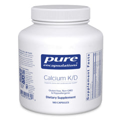Pure Encapsulations Calcium K/D bottle on table highlighting bone-supporting formula.
