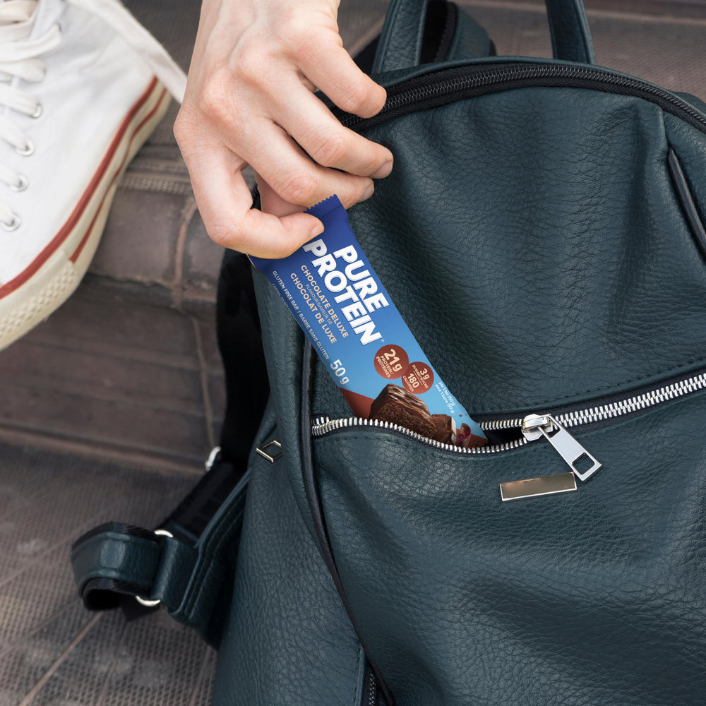 Pure Protein gluten free chocolate bar on desk, quick protein snack for busy days.