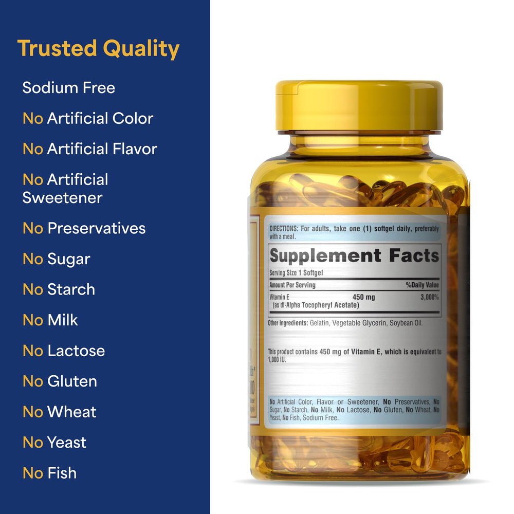 Puritan's Pride Vitamin E softgels held in hand for routine daily use.