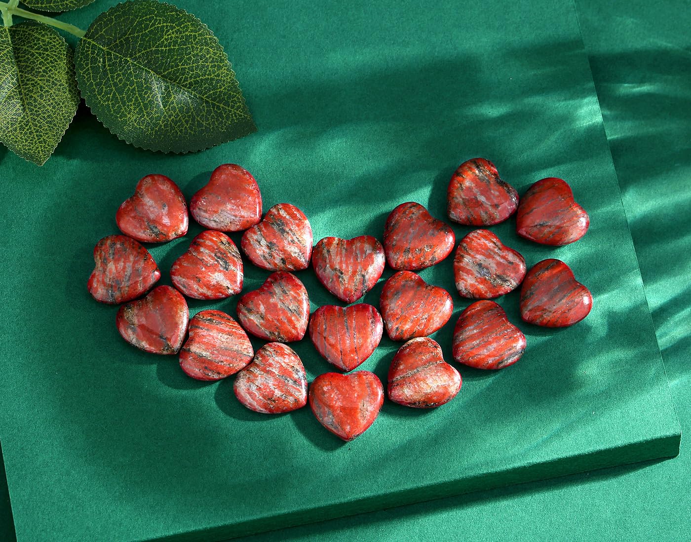 QINJIEJIE polished heart stones in hand for calming energy