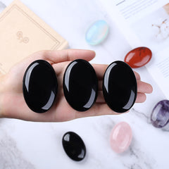 QINJIEJIE polished obsidian palm stone with smooth surface for calm.