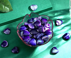 QINJIEJIE purple agate heart in hand for focused breathing practice.