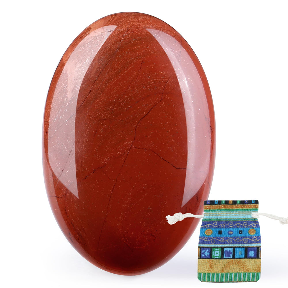 QINJIEJIE Red Jasper palm stone held in hand for focus and calm.