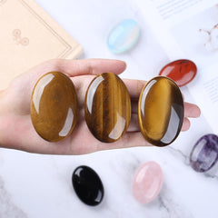 Close-up of QINJIEJIE Tiger Eye palm stone showing natural banding