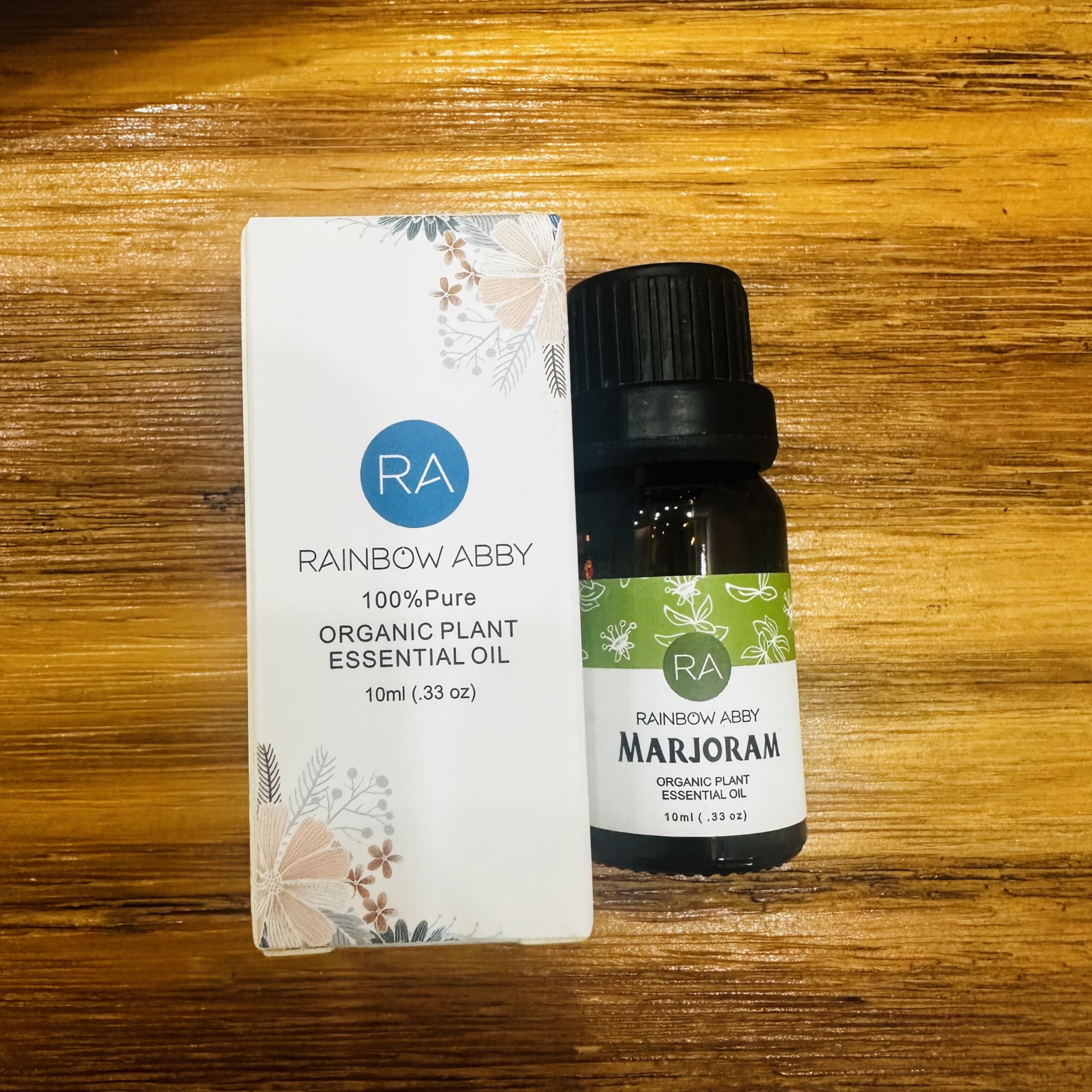 Rainbow Abby Marjoram essential oil beside a diffuser, highlighting aroma ambience.