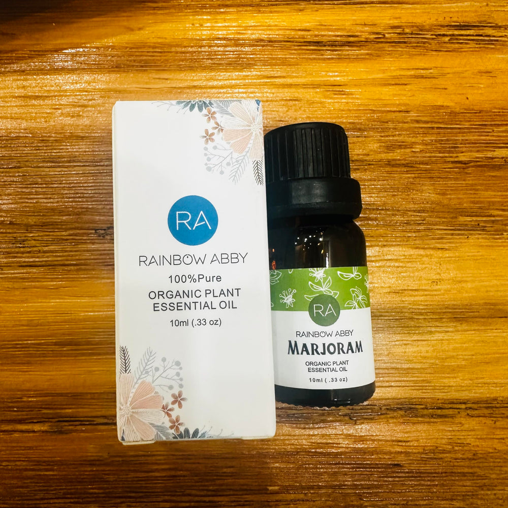 Rainbow Abby Marjoram essential oil beside a diffuser, highlighting aroma ambience.