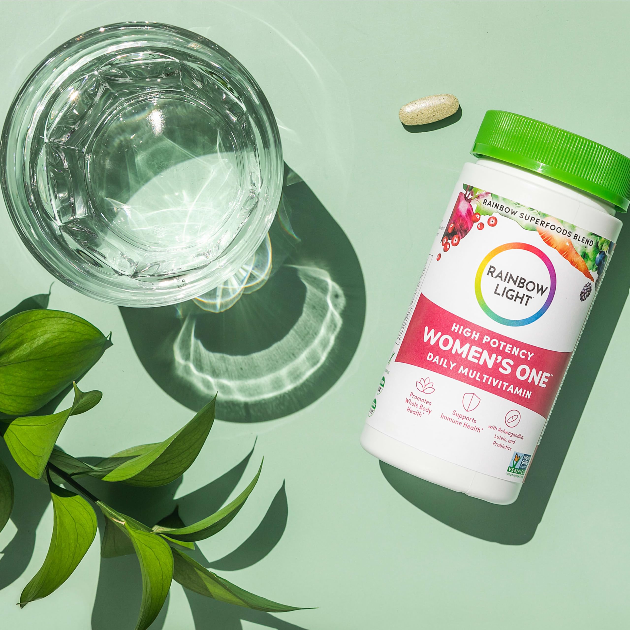 Rainbow Light Women’s One bottle on table conveys home wellness routine.