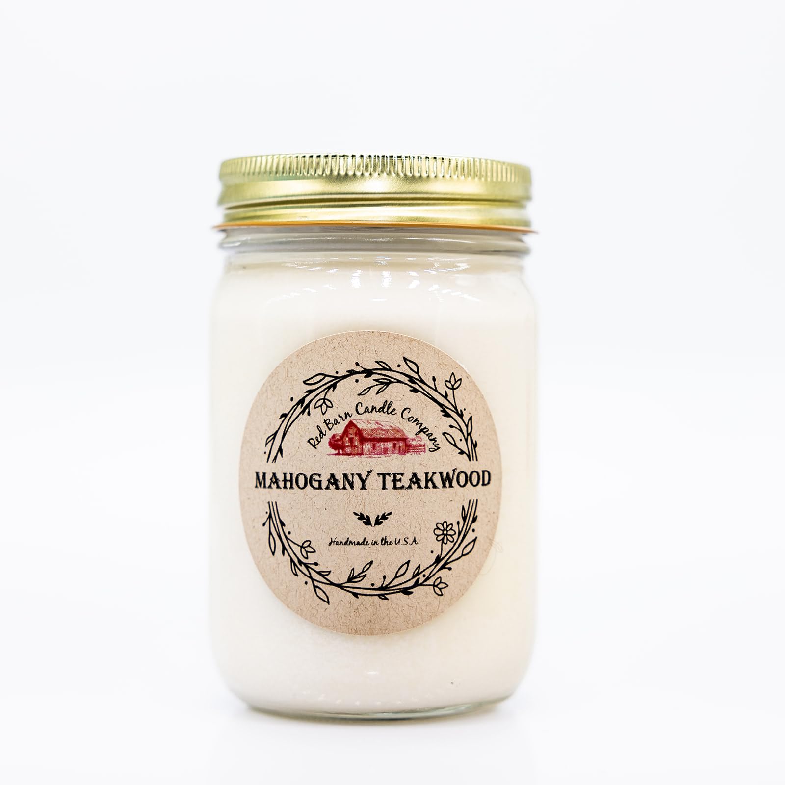Red Barn Teakwood Aromatherapy Candle in a glass jar for warm, inviting ambiance.