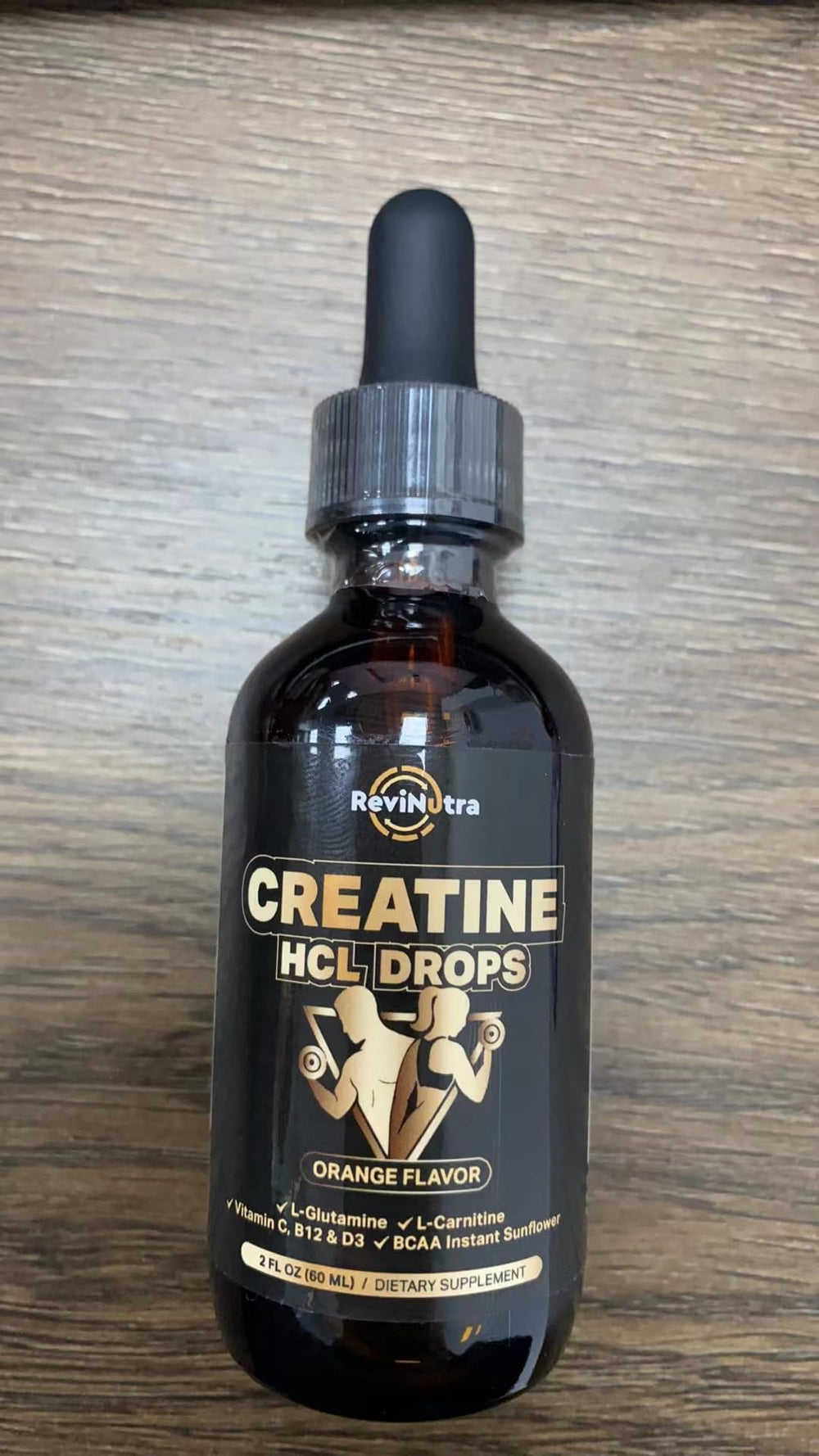 ReviNutra dropper shows 2 ml daily dose for easy use.