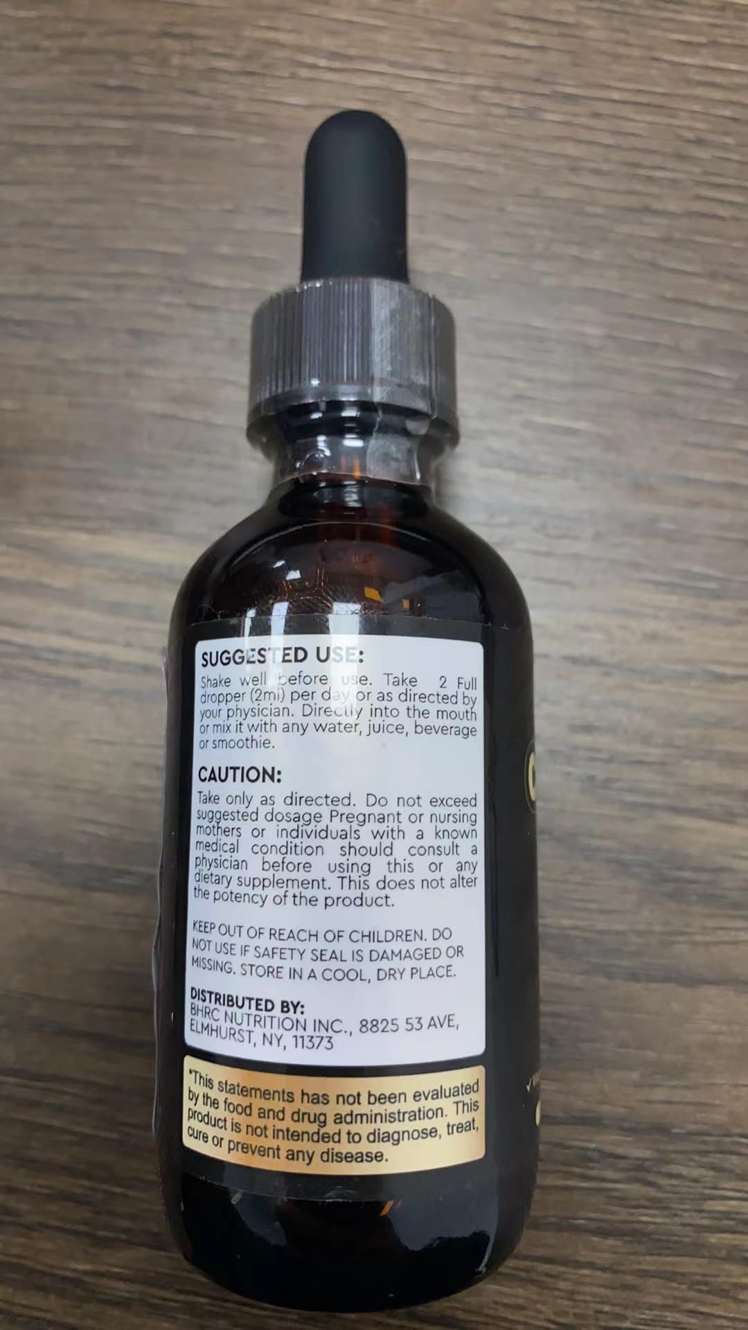 ReviNutra liquid drops mixed in glass with water for convenient intake.