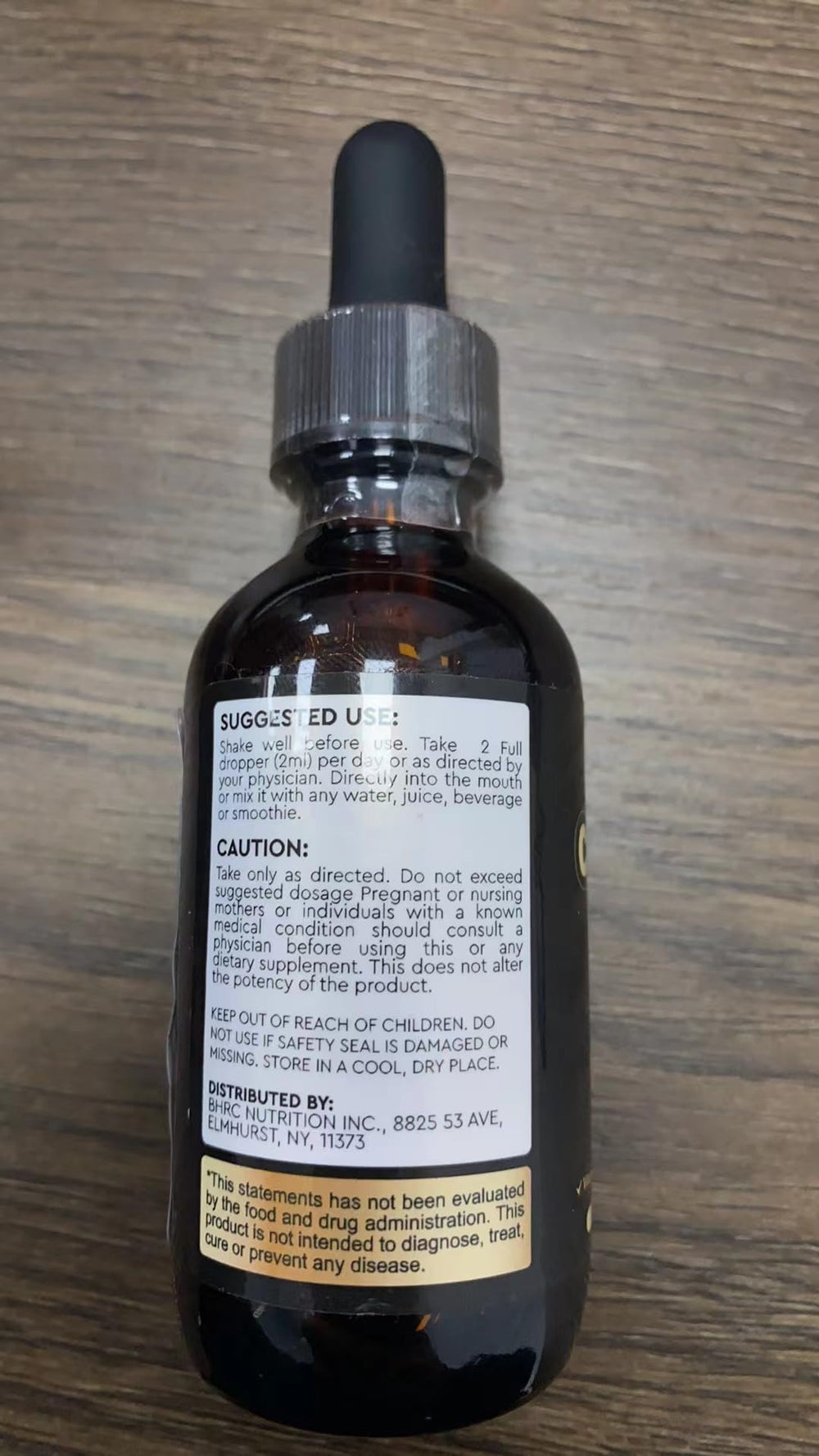 ReviNutra liquid drops mixed in glass with water for convenient intake.