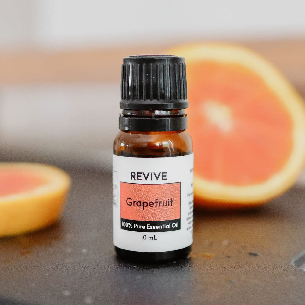 REVIVEEO Grapefruit oil in a diffuser setup for uplifting ambience.