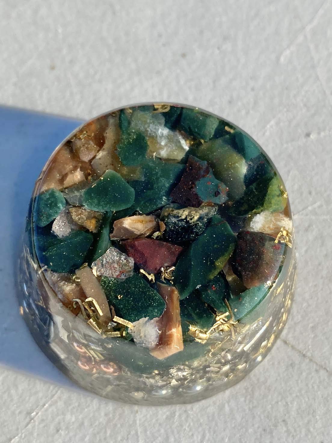 Rise Perspective Bloodstone Orgone Generator top view shows stone layers enhancing calm energy.