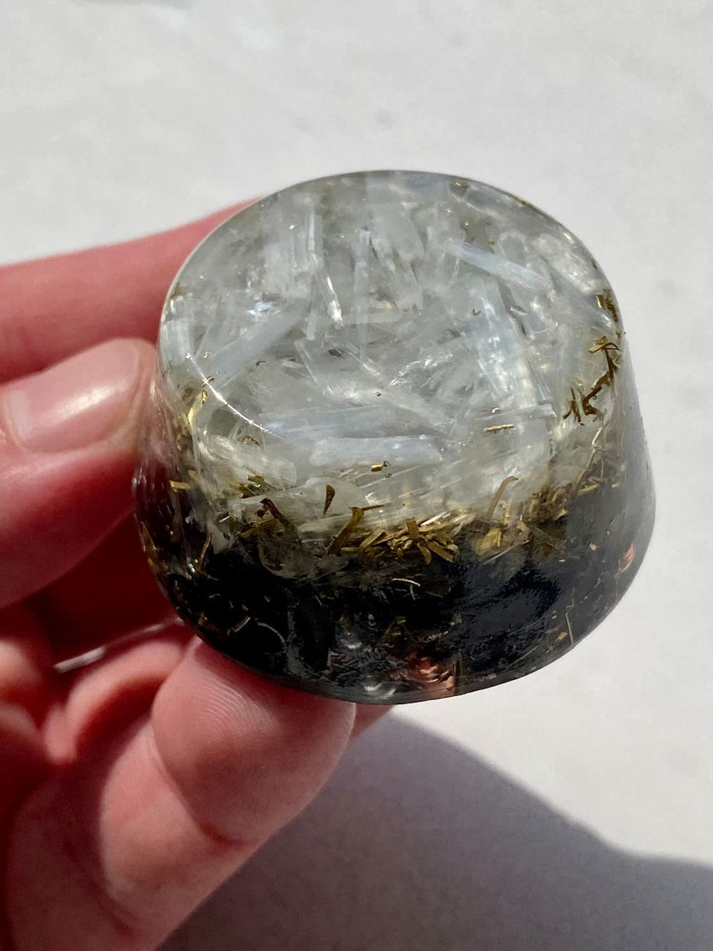 Rise Perspective Selenite Orgone Generator crystal inside shows bionized minerals enhancing positive atmosphere.