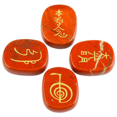 Rockcloud Red Jasper Chakra Palm Stones set with four engraved symbols for balance and focus.