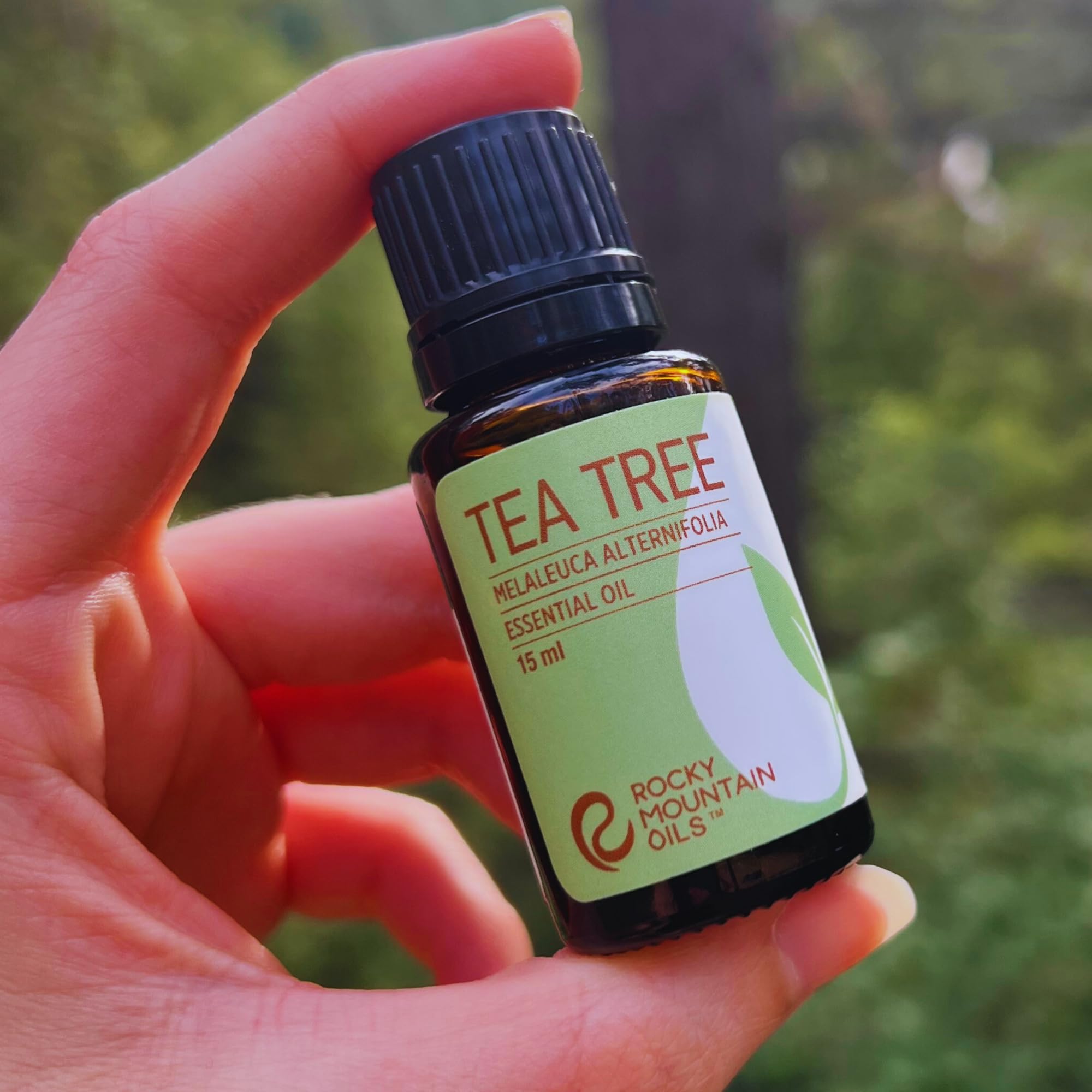 Rocky Mountain Oils Tea Tree oil bottle near vanity highlighting purity and quality